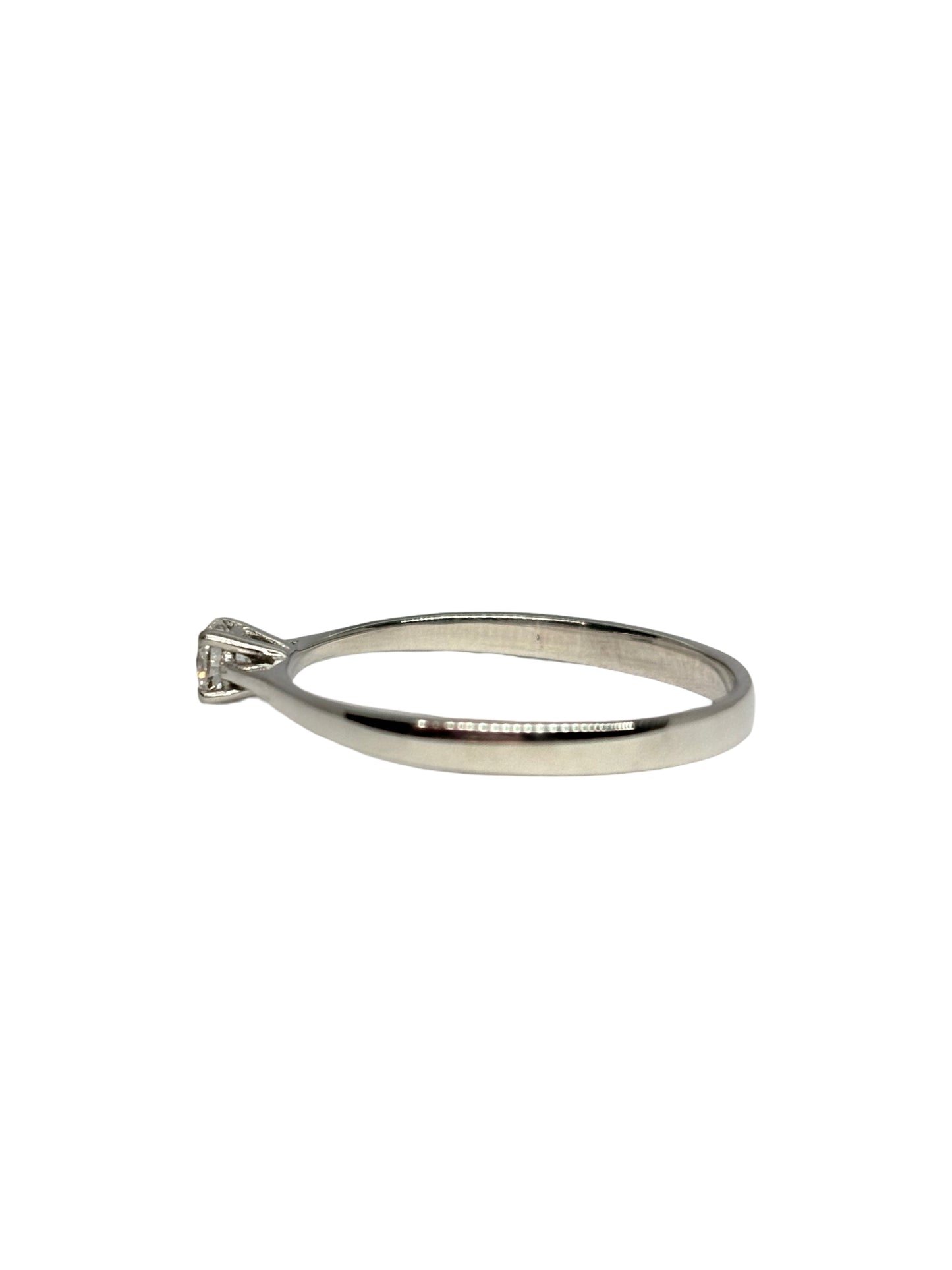 Bague solitaire en or blanc 18K (750/1000) sublimée par un diamant naturel de 0,16 carat. Ce bijou de mariage au design intemporel et élégant met en valeur la brillance d'une pierre centrale étincelante sur une monture fine en or blanc raffinée. Idéale comme bague de fiançailles ou cadeau d'anniversaire précieux pour femme, ce solitaire diamant 0,16 ct incarne le savoir-faire de la joaillerie fine. Un anneau d'exception moderne et lumineux pour marquer un moment inoubliable avec élégance.