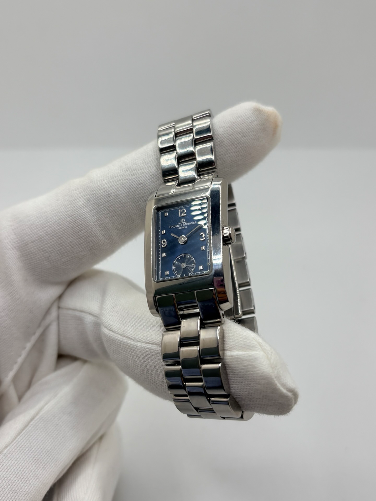 Montre Baume & Mercier Hampton MV045139 équipée d’un mouvement à quartz et d’un boîtier rectangulaire en acier de 20 × 34 mm. Son cadran bleu à chiffres arabes est protégé par un verre saphir. Cette montre Baume & Mercier Hampton est montée sur un bracelet en acier avec boucle déployante double plis. Élégante et contemporaine, elle séduit par ses lignes raffinées et son format rectangulaire emblématique, idéale pour un style chic au quotidien.