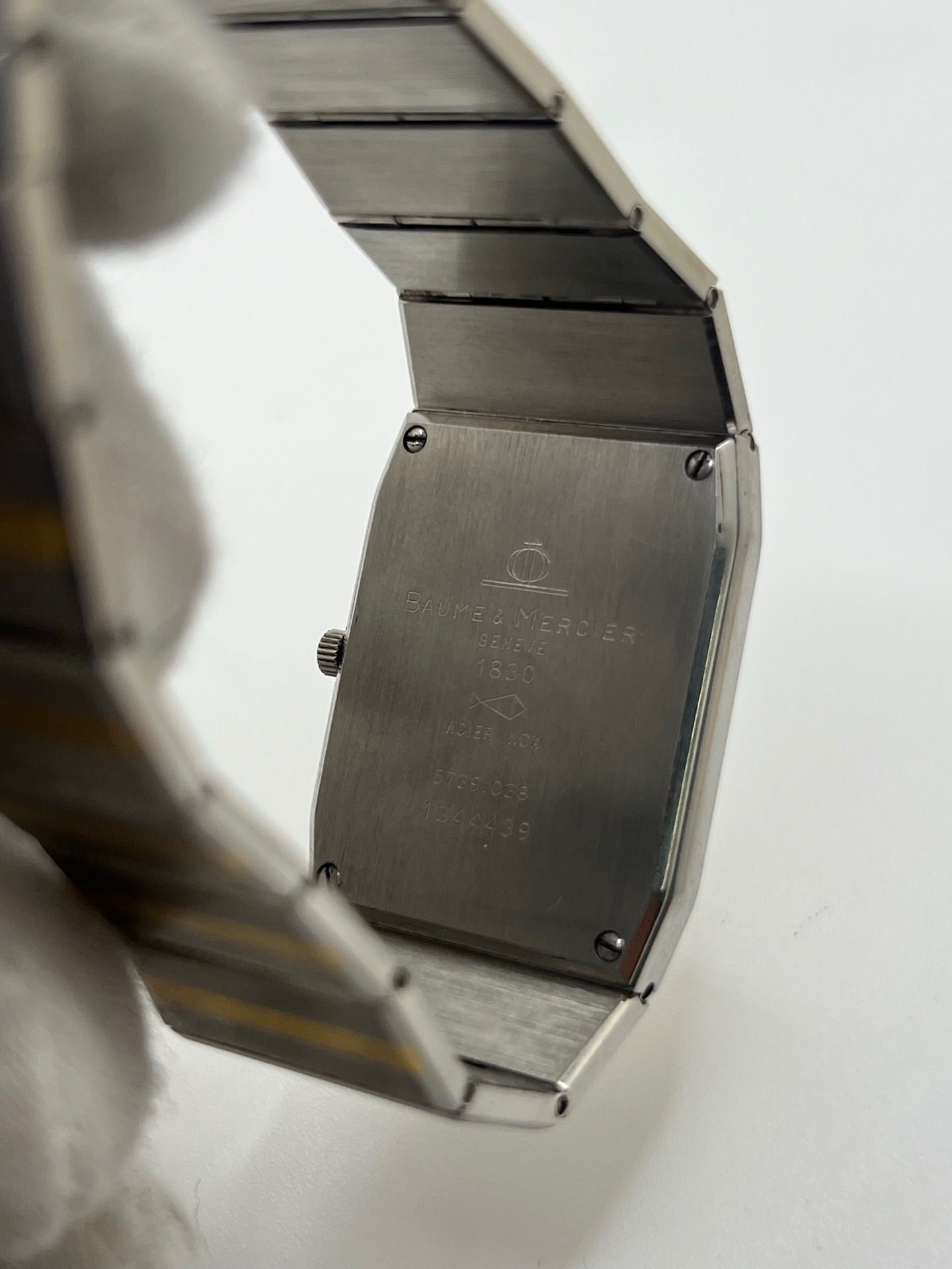 Montre Baume & Mercier Carlo Zebra 5739.038 pour homme/unisexe, mouvement quartz, boîtier acier 25x32 mm, cadran or, verre saphir et bracelet or/acier avec boucle pli. Étanche 10 ATM, d'occasion en bon état, disponible sans coffret ni papiers d'origine. Idéale pour les amateurs de montres de luxe élégantes et intemporelles.