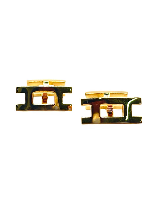 Boutons de manchettes Hermès en or jaune 18K au design élégant et intemporel. Cette paire raffinée en or jaune 750 millièmes reflète le savoir-faire de la maison Hermès avec des finitions soignées et un style sophistiqué. Accessoires de luxe idéals pour compléter une tenue habillée, une cérémonie ou un costume élégant. Boutons de manchettes précieux mêlant distinction, raffinement et élégance masculine contemporaine.
