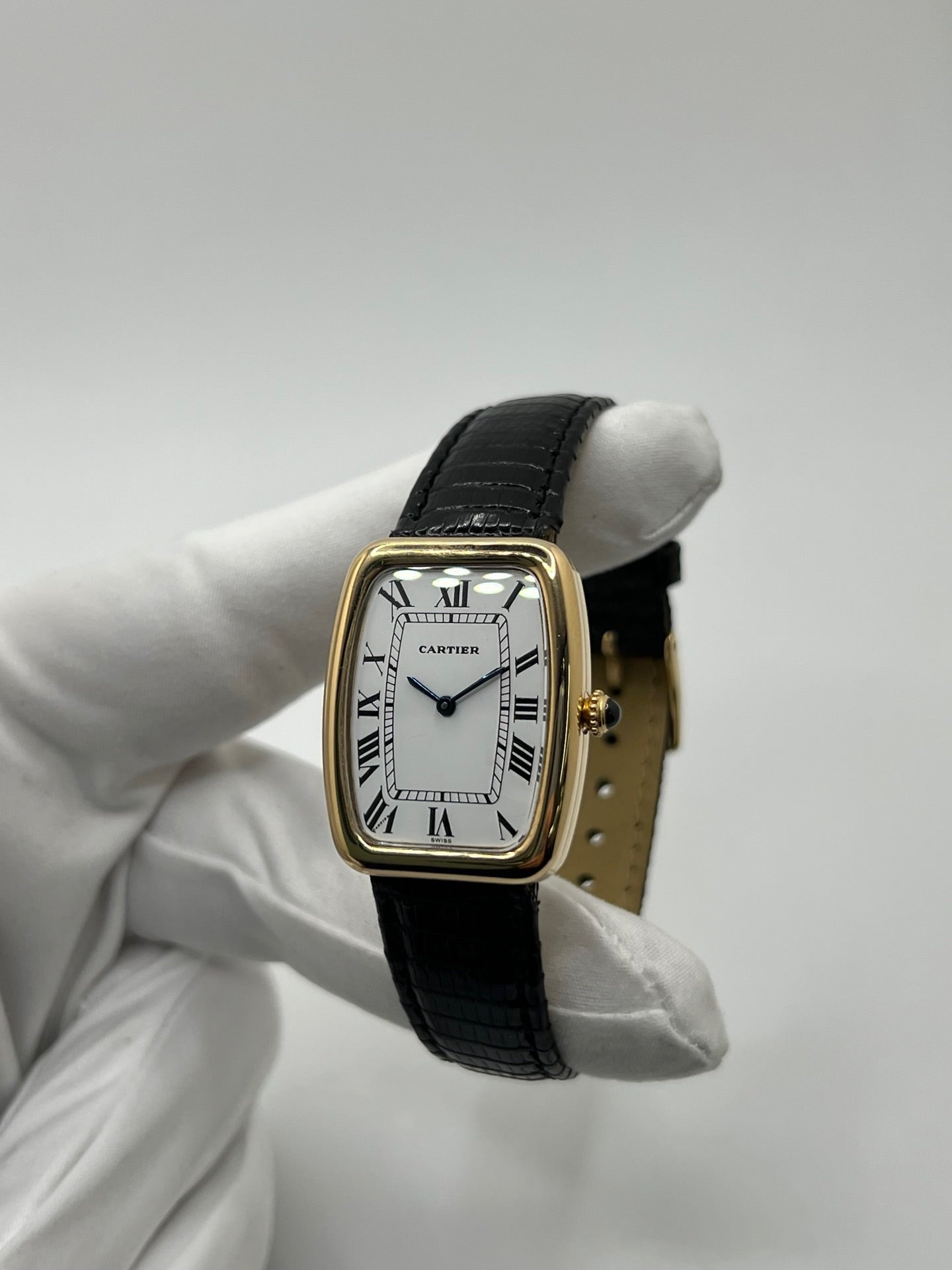 Montre Cartier Fabergé vintage en or jaune avec boîtier rectangulaire de 26 mm, cadran blanc à chiffres romains et bracelet en cuir noir. Ce modèle élégant à remontage manuel, fabriqué vers 1970, séduit par son style intemporel et raffiné. Montre homme ou unisexe d’occasion en très bon état, livrée avec coffret d’origine, idéale pour les amateurs d’horlogerie de luxe et de pièces vintage authentiques.