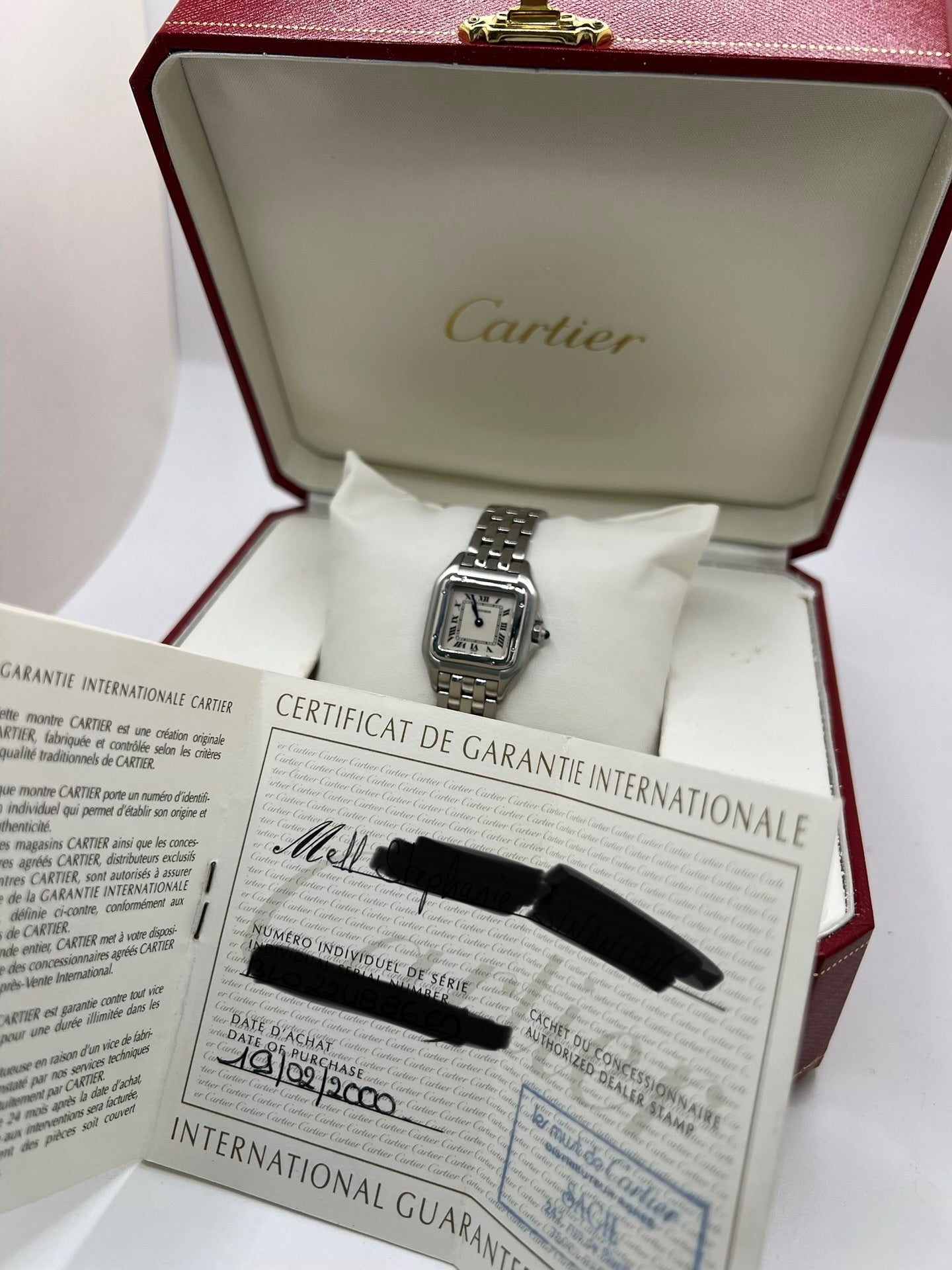 Cartier Panthère référence 1320 en acier avec boîtier de 22 mm, cadran blanc à chiffres romains et mouvement à quartz. Cette montre femme est équipée d'un bracelet en acier avec boucle déployante double pli et d'un verre saphir. Modèle d'occasion en très bon état, révisé par le fabricant en 2026, livré avec son coffret et ses papiers d'origine.