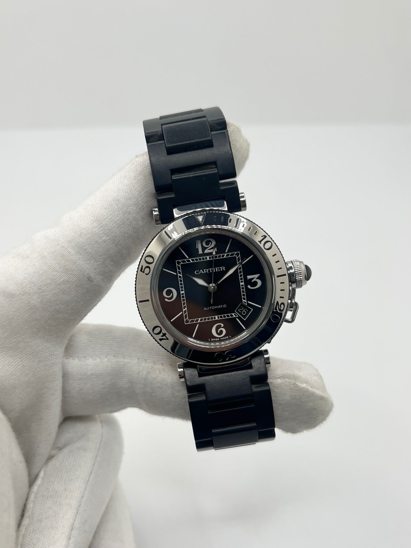 Montre Cartier Pasha Seatimer référence 2790 en acier inoxydable avec boîtier de 40 mm, mouvement automatique calibre 049 basé sur l'ETA 2892-A2 et réserve de marche de 42 heures. Son cadran noir à chiffres arabes est protégé par un verre saphir. Équipée d'un bracelet en acier avec boucle déployante, cette montre est étanche à 10 ATM et dispose d'un guichet date. Vendue avec son coffret et ses papiers d'origine, révisée en interne et en très bon état.