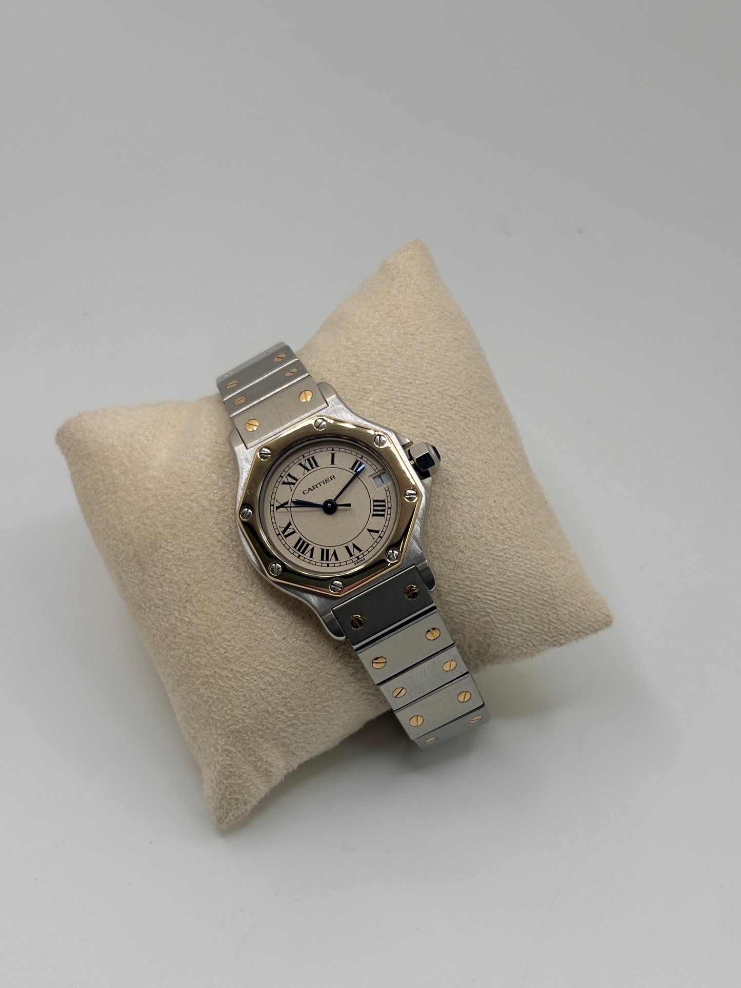Montre Cartier Santos référence 187903 en or et acier avec boîtier de 24 x 31 mm, d'année inconnue et animée par un mouvement à quartz d'exception comptant 7 pierres. Son cadran blanc avec dateur est protégé par un verre saphir et complété par un bracelet en or et acier avec boucle pliante. Cette montre Cartier pour femme d'occasion est en très bon état, révisée en interne et livrée avec son coffret d'origine. Une pièce de luxe iconique disponible à Paris.