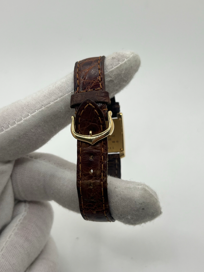 Montre Cartier Tank Française référence 1820 en or jaune 18K, petit modèle pour femme, boîtier rectangulaire emblématique aux lignes droites et élégantes, cadran blanc avec chiffres romains noirs, minuterie chemin de fer et aiguilles bleuies en forme de glaive. Bracelet intégré en acier avec boucle déployante. Mouvement quartz précis. Montre de luxe intemporelle, raffinée et iconique, idéale pour un porté quotidien ou une tenue habillée.