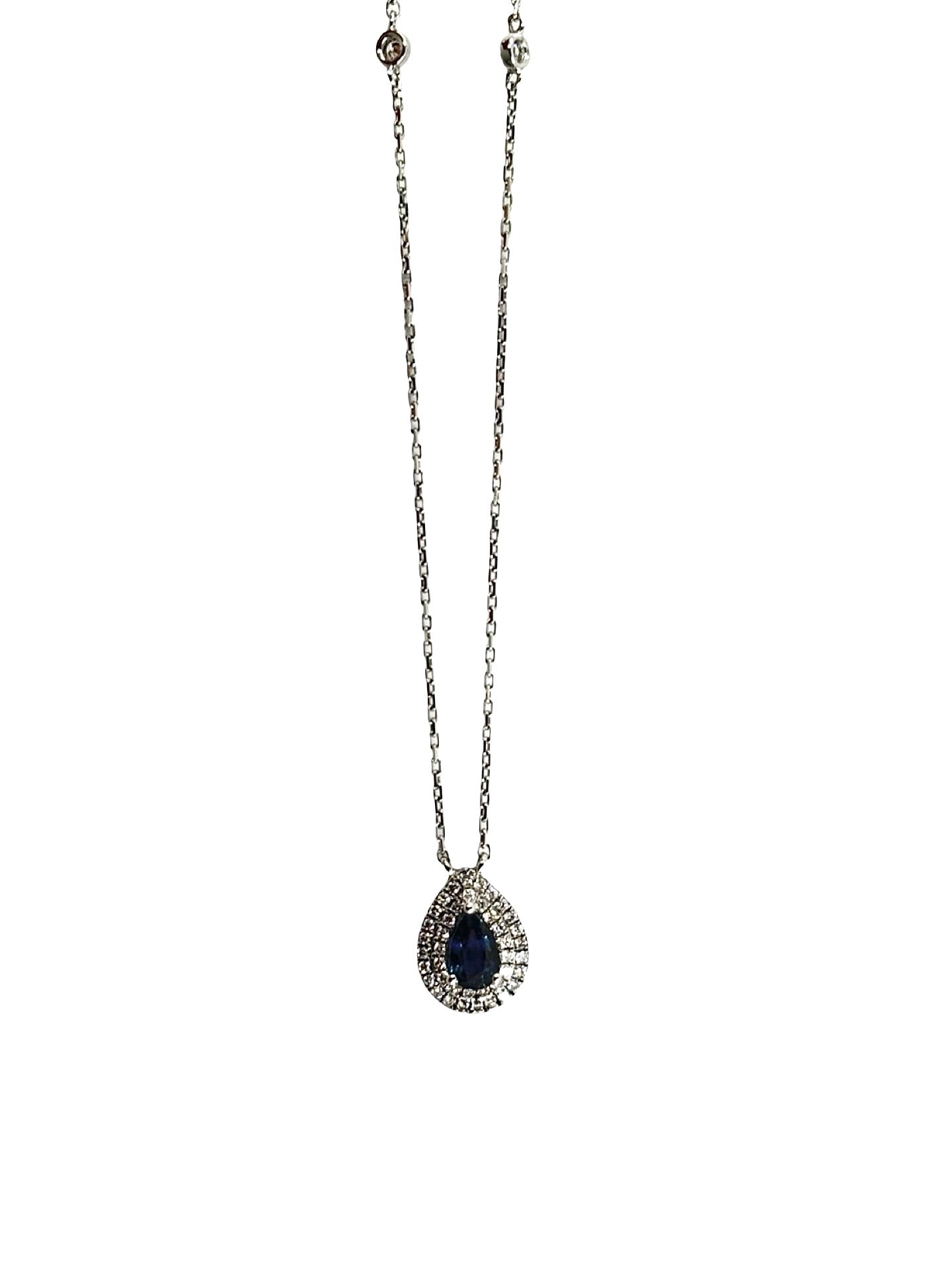 Collier en or blanc composé d’un pendentif serti d’un saphir bleu central entouré de diamants taille brillant totalisant 0,70 carat. Bijou élégant avec chaîne fine en or blanc mettant en valeur la couleur intense du saphir et l’éclat des diamants. Détail du sertissage et finitions précieuses, pendentif raffiné idéal pour bijou de luxe ou occasion spéciale.