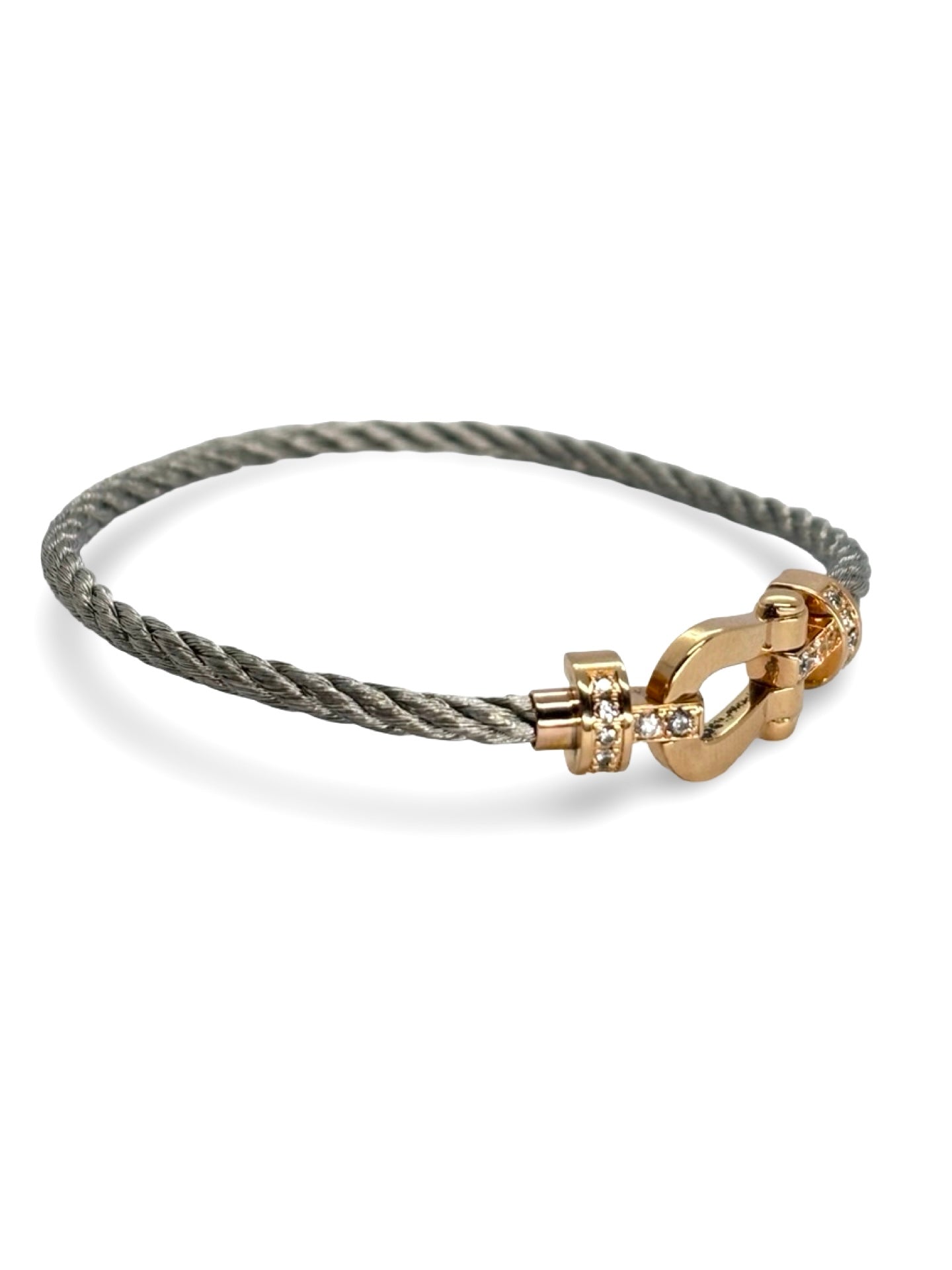 Icône de la Maison Fred, le bracelet Force 10 en or rose et diamants 0,12 ct allie élégance et modernité. Son câble tressé et sa boucle sertie de diamants reflètent un savoir-faire joaillier unique. Symbole de force et de raffinement, il sublime le poignet avec éclat et sophistication.