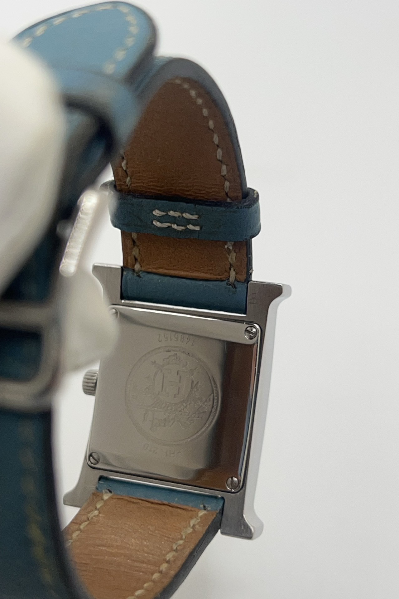 Montre Hermès Heure H HH1.210 en acier avec cadran bleu à chiffres arabes et bracelet cuir Hermès bleu d’origine. Cette montre Hermès femme quartz au design iconique en forme de H incarne l’élégance parisienne et le luxe discret. Modèle Hermès Heure H acier de 21 x 30 mm avec verre saphir, boucle ardillon acier et mouvement quartz fiable. Montre de luxe féminine chic et intemporelle, révisée et livrée avec certificat d’authenticité.