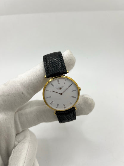 Montre Longines La Grande Classique référence L4.709.2 en plaqué or avec boîtier de 33 mm, cadran blanc à chiffres romains et verre saphir. Ce modèle à mouvement quartz est équipé d’un bracelet en cuir noir avec boucle ardillon en acier. Son design élégant et intemporel en fait une montre de ville raffinée, adaptée aussi bien aux hommes qu’aux amateurs de montres classiques. Pièce d’occasion en très bon état, révisée et prête à être portée.
