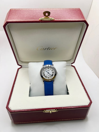 Montre Cartier Must de Cartier Ronde, modèle femme élégant à mouvement quartz. Boîtier rond en métal précieux, cadran blanc raffiné avec chiffres romains, design classique signature Cartier. Bracelet cuir bleu avec boucle ardillon en acier. Verre saphir résistant, diamètre 33 mm. Montre de luxe d’occasion en très bon état, avec légères traces d’usage peu visibles. Révisée en interne le 22 avril 2026. Livrée avec coffret d’origine, sans papiers, disponible à Paris.
