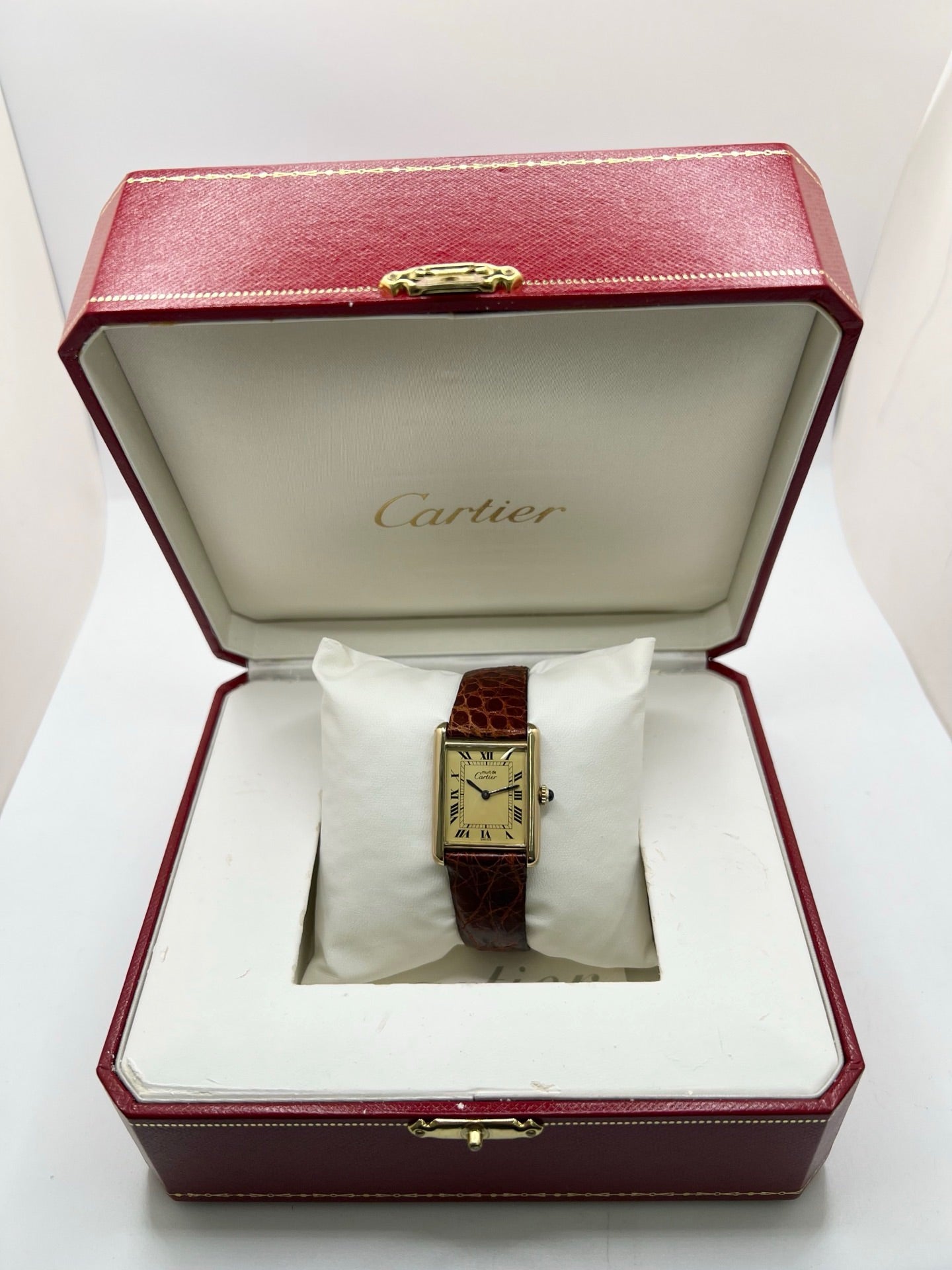 Cartier Tank Must Vermeil en argent avec boîtier rectangulaire de 23 x 30 mm, mouvement à remontage manuel et cadran champagne à chiffres romains. Cette montre unisexe est équipée d’un bracelet en cuir brun avec boucle ardillon en acier et d’un verre saphir. Modèle d’occasion en très bon état, révisé en interne en 2026. Une montre Cartier élégante et intemporelle, livrée avec coffret d’origine, sans papiers d’origine.
