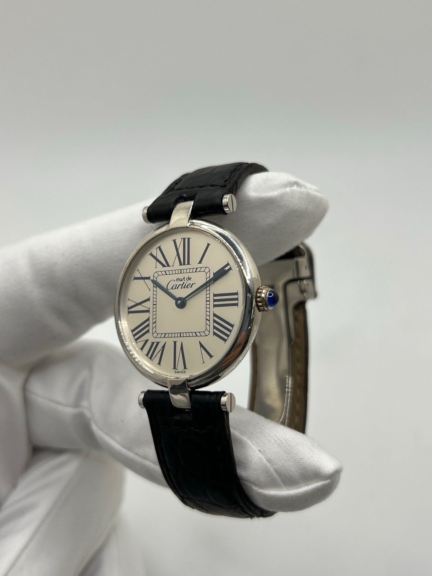 Montre Cartier Must Vendôme référence 1860 avec boîtier rond en argent de 30 mm et cadran argent à chiffres romains signature. Mouvement quartz fiable et élégant, protégé par un verre. Bracelet en cuir noir avec boucle ardillon offrant un porté confortable et raffiné. Modèle emblématique au style classique et intemporel, idéal pour une tenue habillée ou une collection de montres vintage. Montre d’occasion en très bon état, révisée et prête à être portée au quotidien.