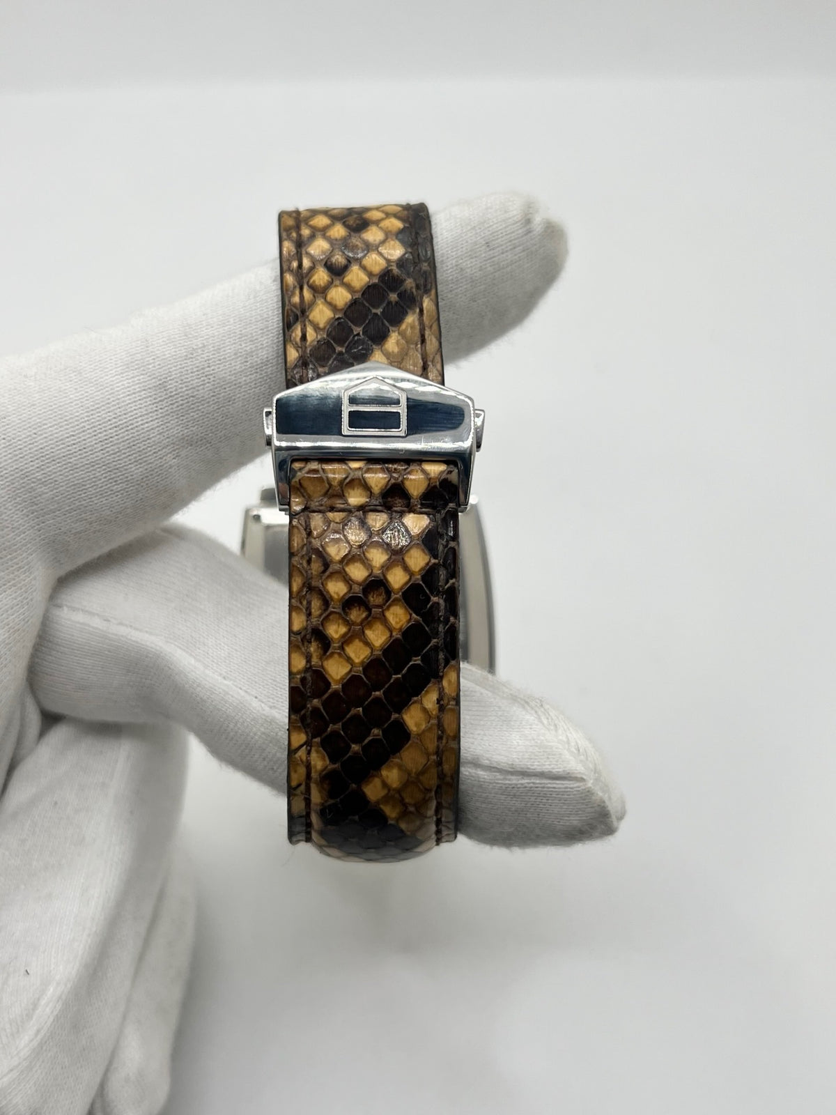 Montre TAG Heuer Monaco Calibre 6 WW2115 pour homme, équipée d’un mouvement automatique offrant une réserve de marche de 42 heures et du calibre 6 doté de 27 pierres. Son boîtier en acier de 37 mm accueille un cadran brun au style élégant et distinctif. Cette TAG Heuer Monaco est montée sur un bracelet en cuir de serpent avec boucle déployante en acier. Dotée d’un affichage de la date, elle allie design emblématique et savoir-faire horloger. Vendue avec son coffret d’origine, en très bon état.
