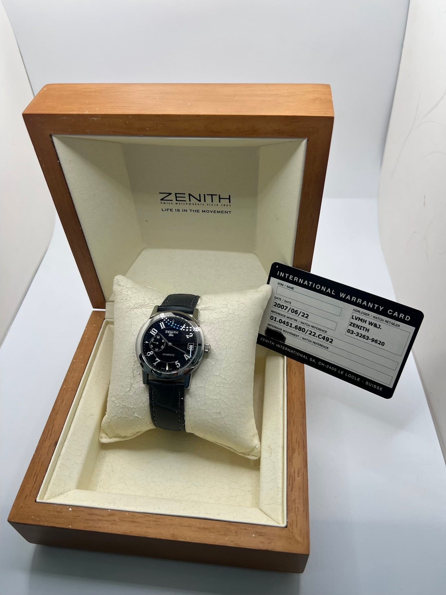 Montre Zenith Port Royal automatique en acier, modèle homme ou unisexe de 2007, équipée d’un boîtier de 37 mm et d’un élégant cadran noir à chiffres arabes. Cette montre d’occasion en très bon état dispose d’un verre saphir, d’une fonction date et d’une petite seconde. Son bracelet en cuir noir avec boucle ardillon souligne son style raffiné. Une montre Zenith Port Royal de luxe au design intemporel, idéale pour les passionnés d’horlogerie et les amateurs de pièces élégantes.