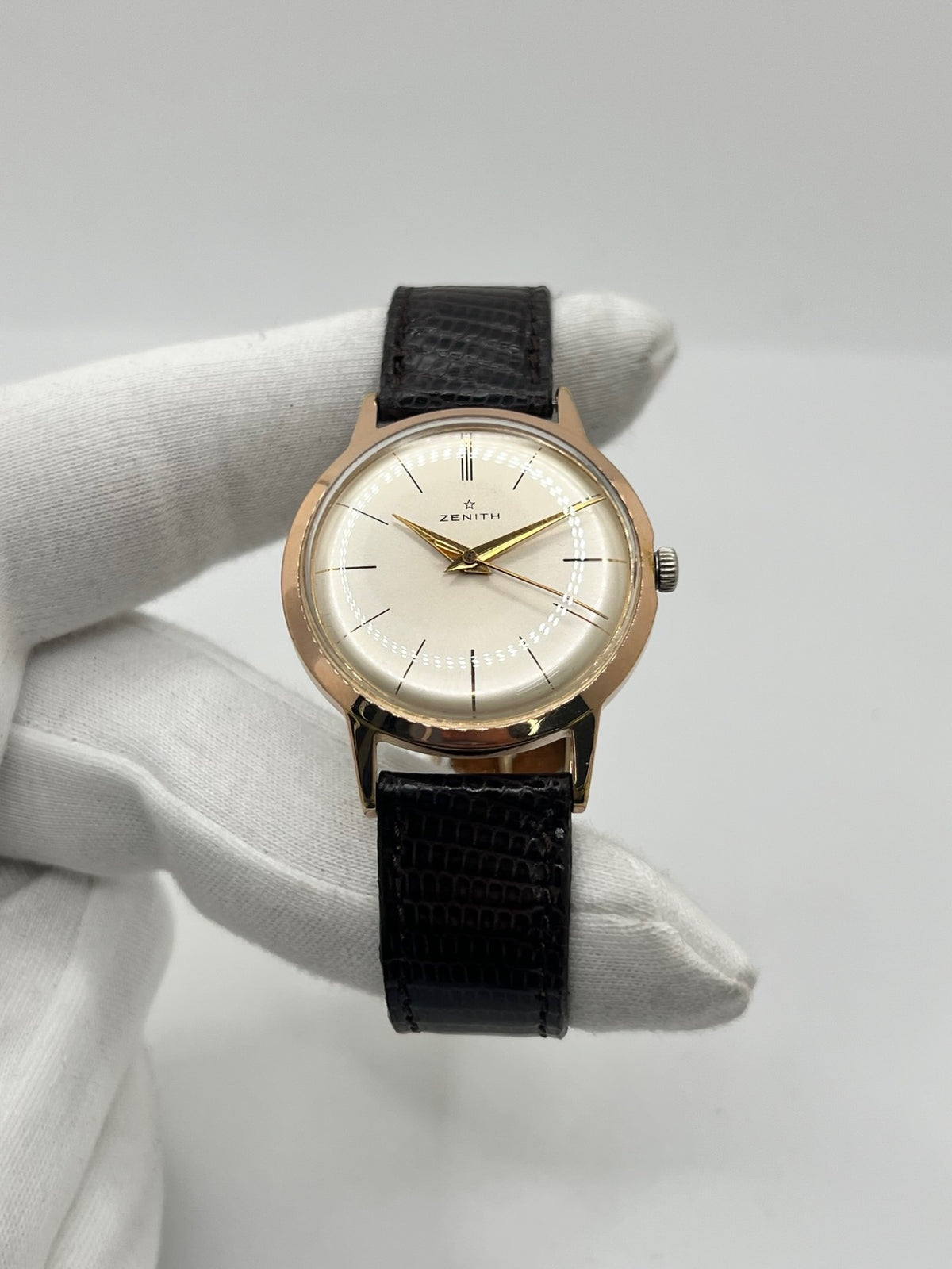 Montre Zenith Stellina vintage à remontage manuel, dotée d’un boîtier plaqué or et d’un élégant cadran champagne. Cette montre Zenith se distingue par son style classique et intemporel, emblématique de l’horlogerie traditionnelle. Elle est équipée d’un bracelet brun en cuir de lézard, complété par une boucle ardillon en acier. Avec son esthétique raffinée et son allure rétro, la Zenith Stellina séduit les amateurs de montres anciennes et de pièces horlogères au charme authentique.