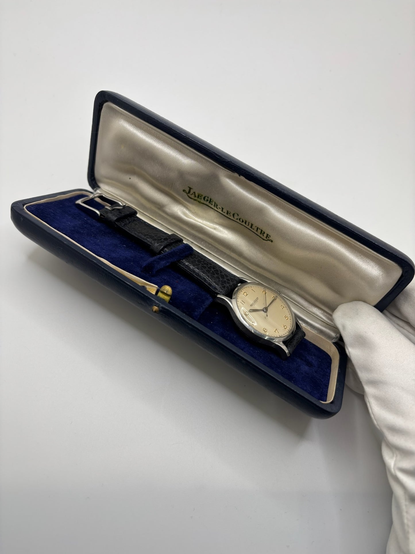 Montre Jaeger-LeCoultre vintage en acier datant des années 1950, équipée du calibre P478 à remontage manuel. Son cadran argent à chiffres arabes est protégé par un verre plexiglas et associé à un bracelet en cuir noir. Avec son boîtier de 31,5 mm et son design sobre et élégant, cette montre mécanique de collection illustre le savoir-faire horloger suisse de l'époque. Pièce ancienne recherchée par les amateurs de montres vintage et de garde-temps de caractère.