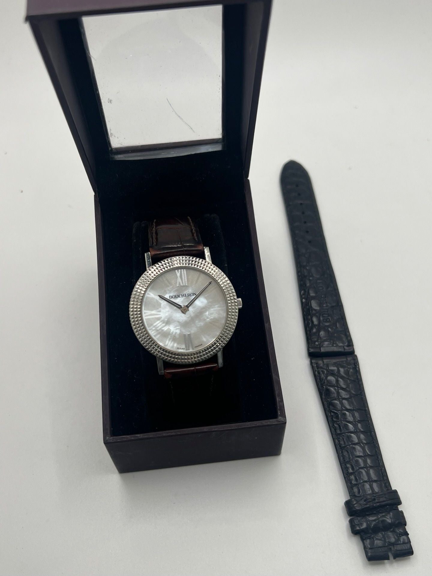 Découvrez l’élégance intemporelle de la Boucheron Ronde Clous de Paris, une montre Boucheron haut de gamme alliant raffinement et savoir-faire horloger. Ce modèle Ronde Clous de Paris se distingue par son cadran en nacre, subtilement mis en valeur par un boîtier en acier de 38 mm et un bracelet en peau d’alligator brun, synonyme de luxe et de confort.