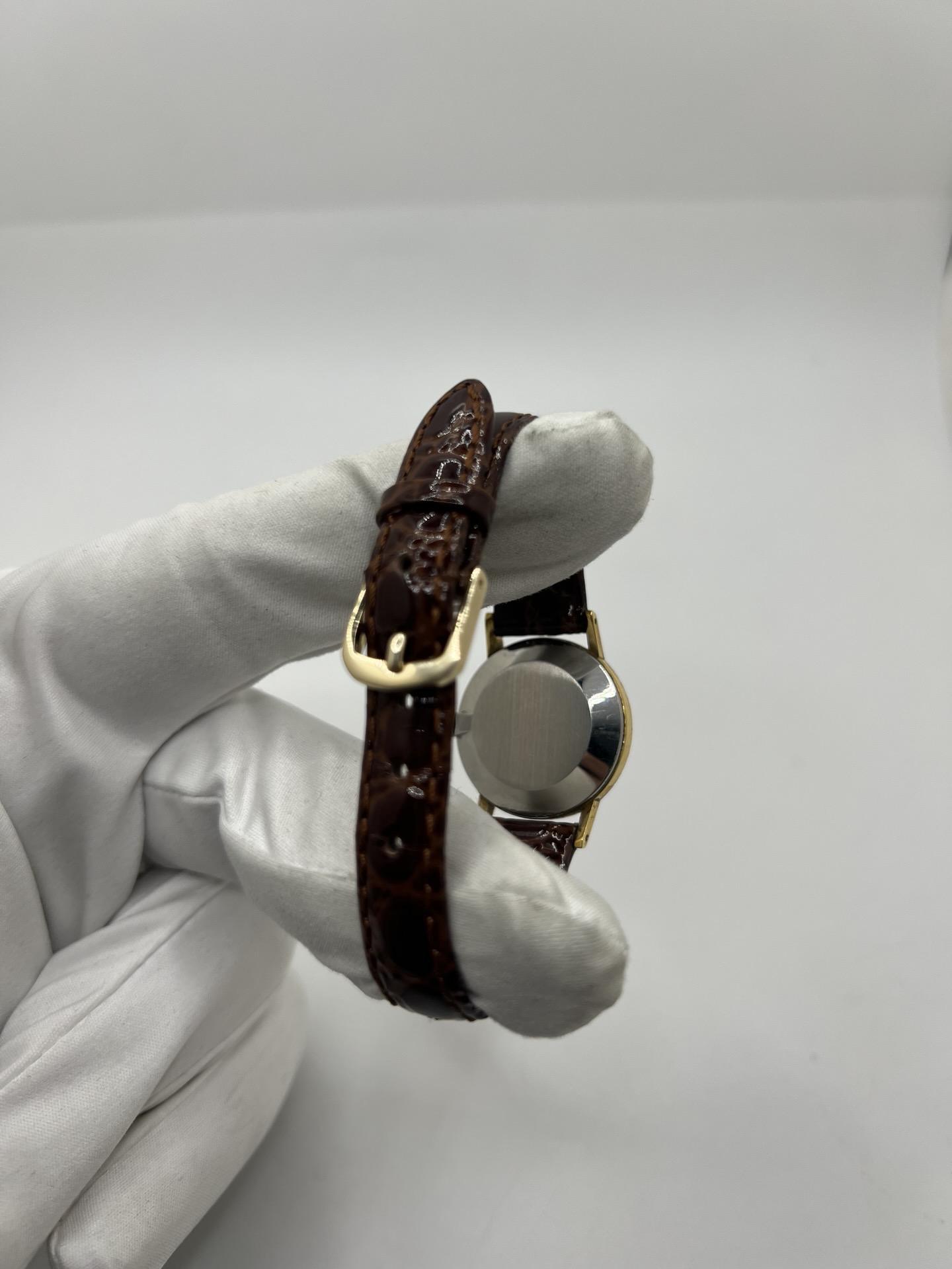 Montre Omega De Ville 511.0392 vintage de 1973 en acier plaqué or avec cadran doré et bracelet cuir brun. Cette Omega Seamaster De Ville mécanique de 24 mm est équipée du calibre Omega 625 à remontage manuel, apprécié pour son charme horloger authentique. Élégante et raffinée, cette Omega vintage femme séduit par son style intemporel inspiré des années 70. Montre révisée avec boucle Omega d’origine, boîte Omega et certificat d’authenticité.