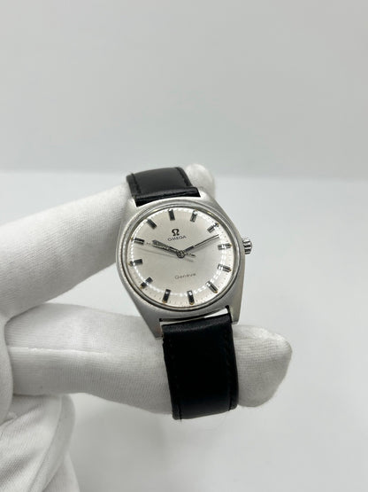 Montre Omega Genève 135.041 vintage de 1969, équipée d’un mouvement à remontage manuel avec calibre 601, offrant une réserve de marche de 48 heures. Son boîtier en acier de 34 mm est associé à un cadran argent à index bâtons, protégé par un verre Plexiglas. Cette Omega Genève est montée sur un bracelet noir en cuir de vache avec boucle ardillon en acier. En bon état, elle présente des traces d’usure visibles.