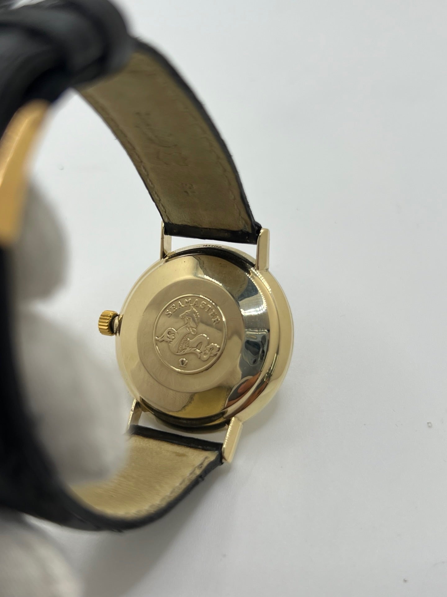 Montre Omega Seamaster DeVille vintage de 1961 en or jaune 14 carats, équipée d’un mouvement automatique calibre 560. Boîtier rond de 34 mm avec verre plexiglas, cadran champagne à index bâtons et date. Bracelet en cuir de crocodile noir avec boucle en or. Montre homme élégante et intemporelle, en bon état avec traces d’usure, récemment révisée, idéale pour collection ou usage quotidien.