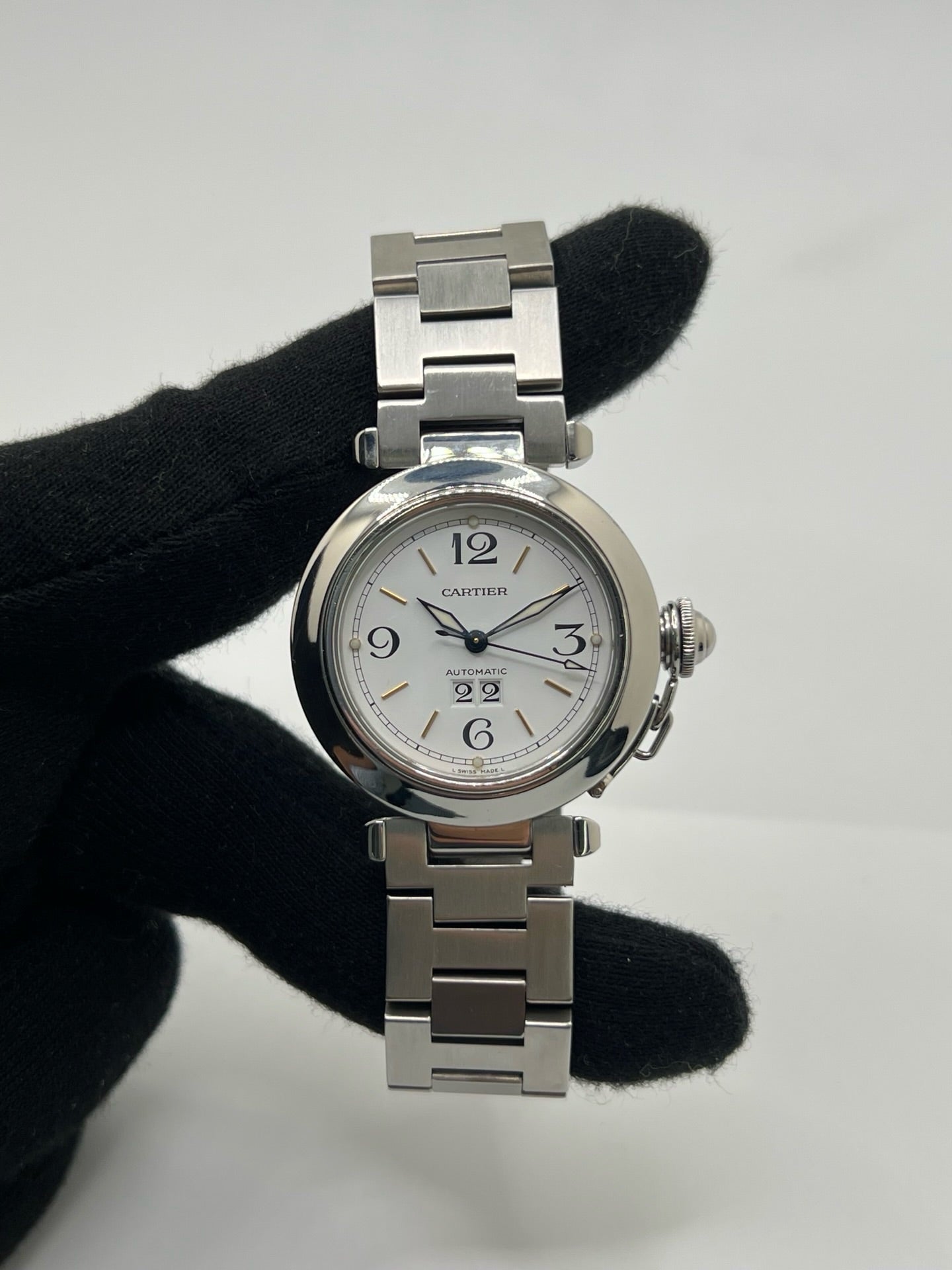 Montre de luxe Cartier Pasha C référence 2475 en acier, équipée d’un mouvement automatique calibre 052. Son boîtier de 35 mm et son cadran blanc à chiffres arabes offrent un style élégant et intemporel. Avec verre saphir, étanchéité 10 ATM et bracelet en acier, cette Pasha C combine performance, précision et raffinement.